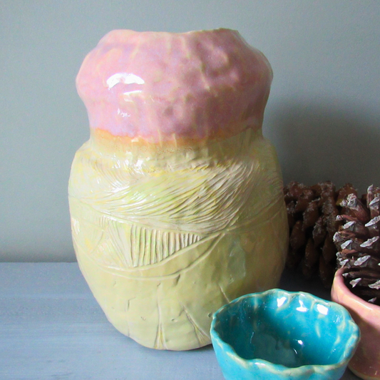 pink and yellow ceramic coil pot