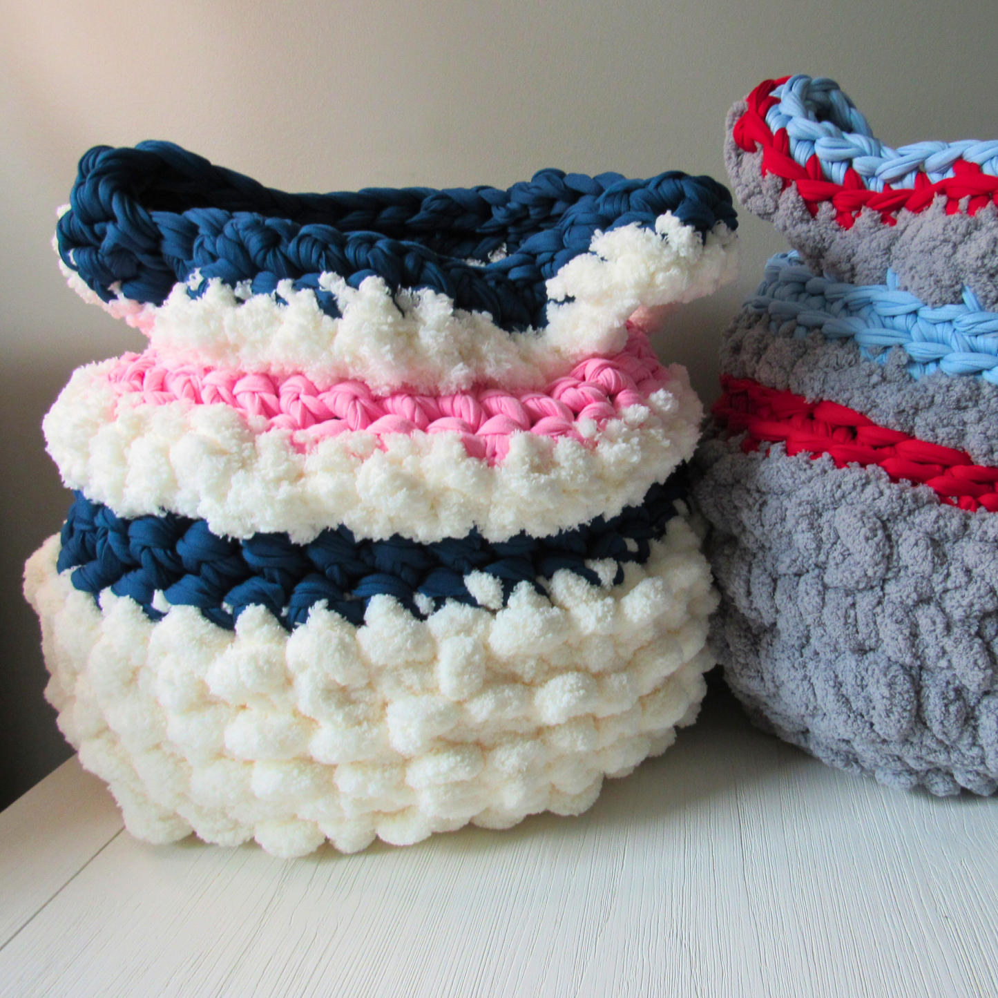 crocheted storage basket in white and grey color schemes