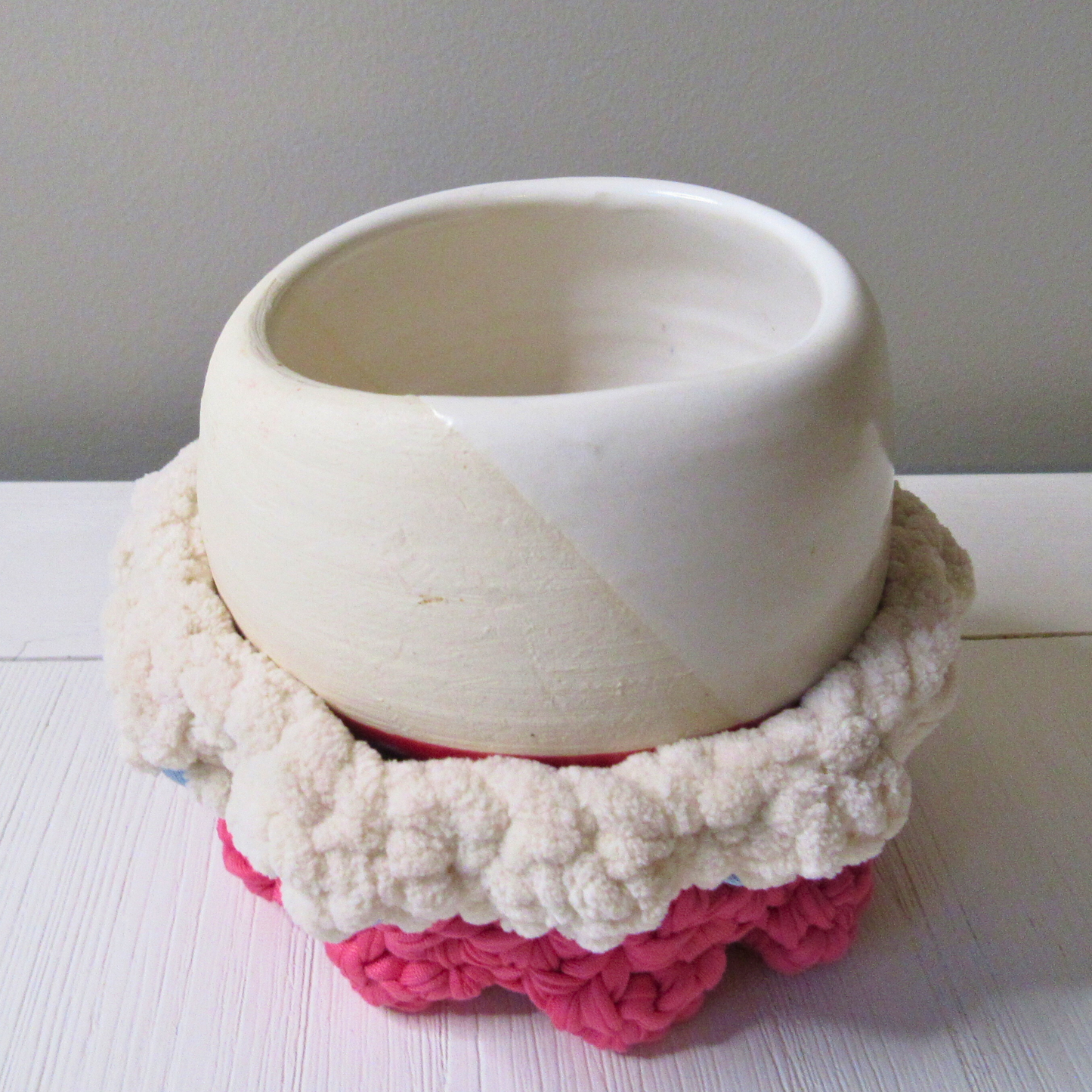Cozy Mini Pedestal Functional Decorative Basket in cream holding a small ceramic pot